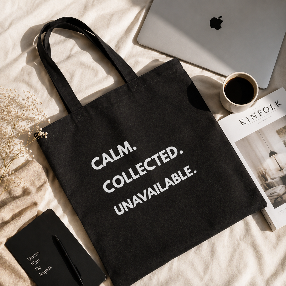 Black Calm Collected Unavailable quote canvas tote bag flat lay with laptop coffee notebook and Kinfolk magazine