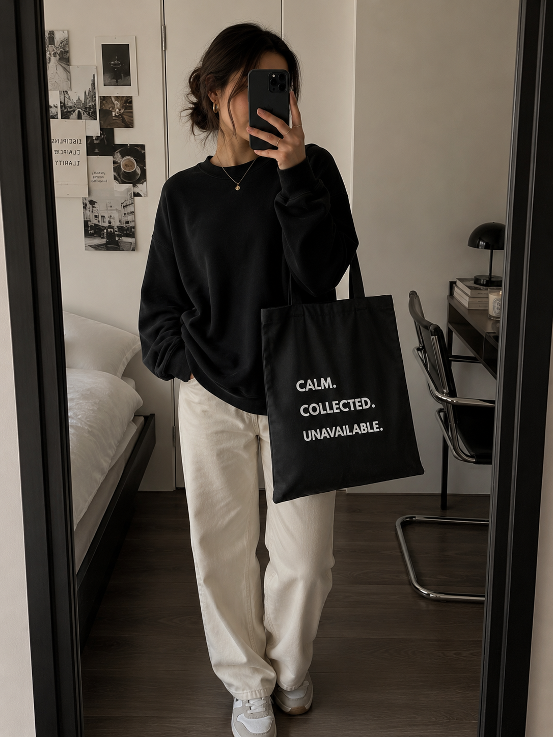 Black Calm Collected Unavailable quote tote bag styled with casual neutral outfit in aesthetic mirror selfie